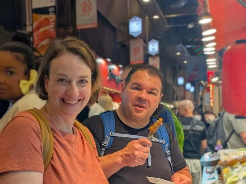 Local foodie guide offering market tastings at Nishiki Market on a kyoto food tour, Kyoto, Japan